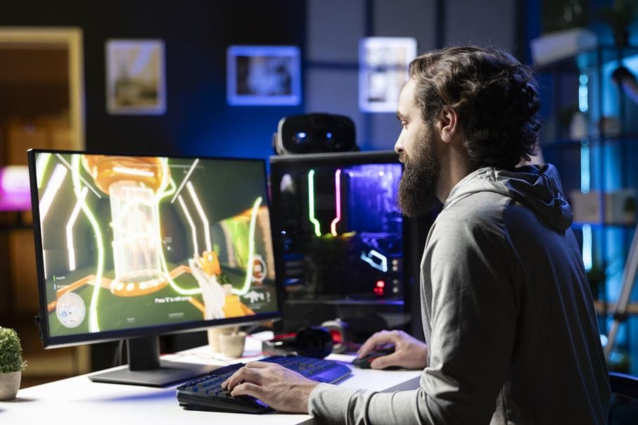 Mann spielt Videospiel am Computer zu Hause.